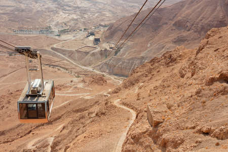 Desert landscape with cable car of the Masada cableway, Israel