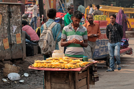 Delhi, India - November 20, 2015: An Indian man selling his fresh produce on a crowded street market of Old Delhiのeditorial素材