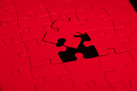 An assortment of vibrant puzzle pieces, some of which are missing, revealing gaps that invite the viewer to solve the puzzleの写真素材