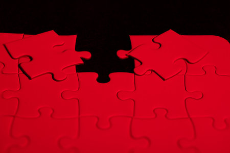 Red puzzle to choose which piece fits in the holeの写真素材