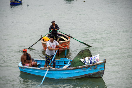 Lima - Peru, May 21, 2023 - Lima's fishing port is a hive of activity with fishermen repairing nets and preparing their boatsのeditorial素材
