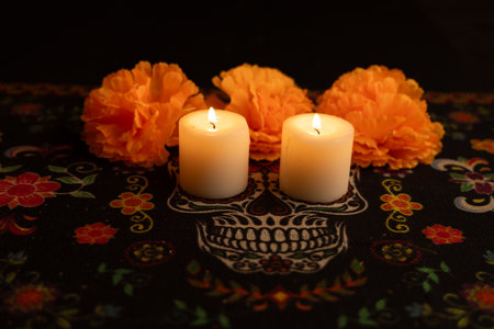 A dark background highlights three lit candles surrounded by vibrant orange marigold flowers. The...