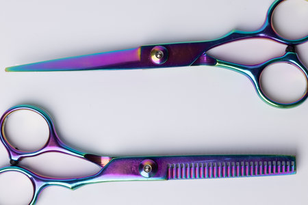 etailed shot from above two barber scissors positioned centrally on a white surface. The clean, sharp lines of the scissors are emphasized, making it perfect for professional grooming imageryの写真素材