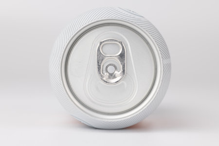 Can tilted and centered with detailed focus on the can's opening, captured horizontally against a clean white background for crisp product imageryの写真素材