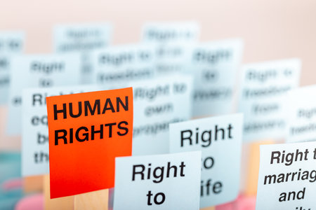 Posters showcasing human rights in light blue and red text, set against a clean white background. Emphasizes the importance of human rightsの写真素材