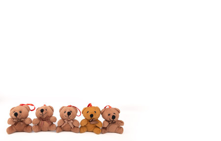 A delightful lineup of teddy bears dressed in Christmas gear, arranged neatly on a white background. Great for holiday decorations and cardsの写真素材