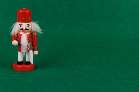 This whimsical nutcracker, featuring original hair, is displayed on a bright green background, capturing the essence of Christmas joyの写真素材