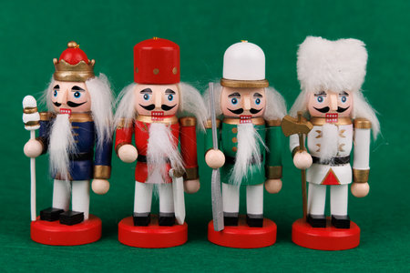 An elegant wooden nutcracker with original hair is showcased on a deep green canvas, perfect for...