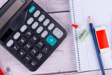 Financial planning for tax day with April 15 deadline highlighted on a wooden tableの写真素材