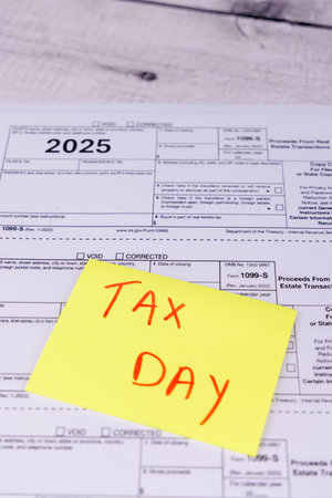 April 15 tax preparation with financial tools and tax paperwork on a white tableの写真素材