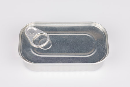 Silver tin on a white surface offers neutral space ideal for packaging and minimalist layouts.の写真素材