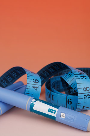 Horizontal layout showing pens with tape, concept of pharmacological support for obesity.の写真素材