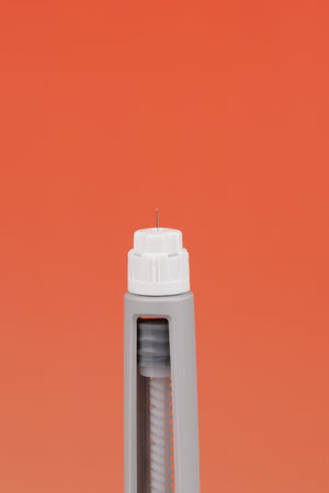 Semaglutide pen placed horizontally on a red gradient background, ideal for topics on diabetes care...