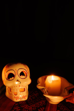 Soft candlelight shines from a white skull on a traditional cloth, with magnolias and candles...