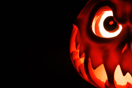Creepy Halloween lantern glowing in black scary setting.の写真素材