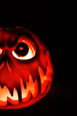 Terrifying jack o lantern pumpkin glowing bright in total darkness.の写真素材