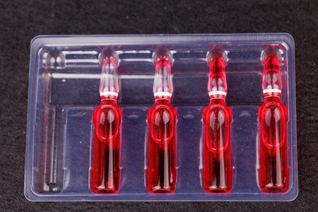 Injectable ampoules displayed on dark background for health supportの写真素材