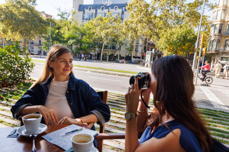 Friends discuss tourist attractions and plan their sightseeing day with excitement.の写真素材
