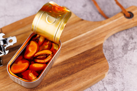 Marinated seafood in metal can placed on rustic wood table, Mediterranean food concept.の写真素材