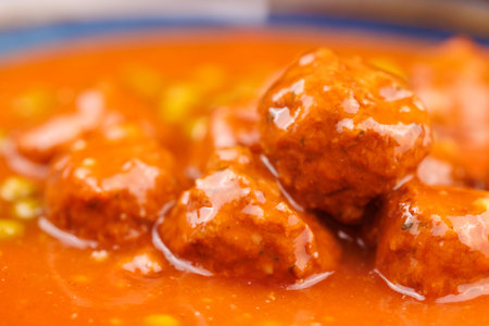 Open can of meatballs and peas, rustic background with wooden board, ready meal scene.の写真素材