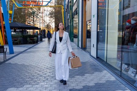 Portrait of a young beautiful woman with shopping bags in the cityの写真素材
