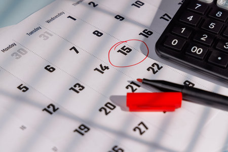 Financial tax season reminder with April 15 marked on a calendar. Ideal for representing IRS...