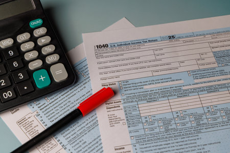 Financial tax deadline reminder with color Form 1040 and a calculator. Sunlight on the desk...