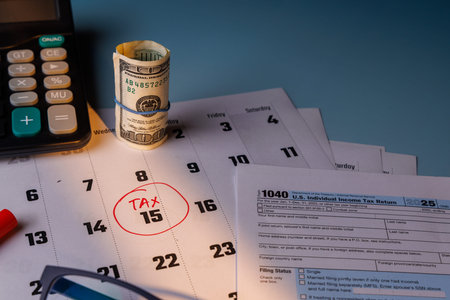 US income tax filing concept with a 100 dollar bill and color Form 1040. Soft sunlight highlights...