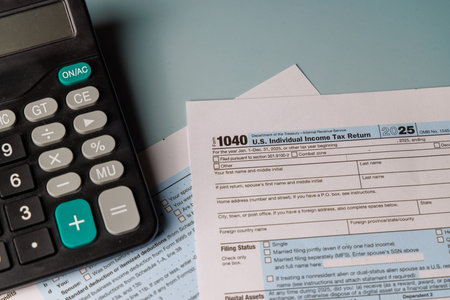 US income tax filing concept with color Form 1040. Soft sunlight highlights IRS documents, money...
