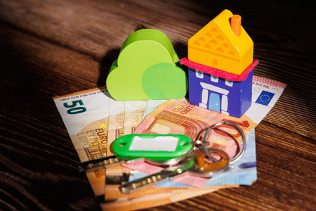 Housing crisis in Europe with a small toy house on Euro bills. Perfect for representing the...