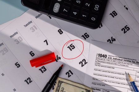 Financial tax deadline concept with April 15 circled and cash. Ideal for representing IRS tax...