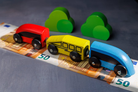 Wooden toy train on money. Ideal for representing the impact of smart investments, profitable...