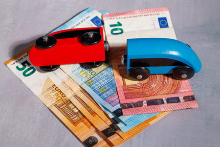 Concept of financial failure in Europe with a toy train on Euro cash. Perfect for illustrating...