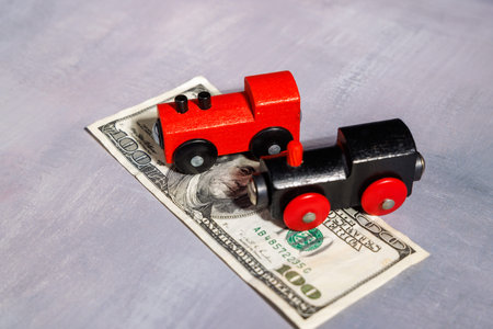 Small train on cash. Perfect for illustrating the high cost of public transport, financial exclusion and the struggle for affordable travel now.の写真素材