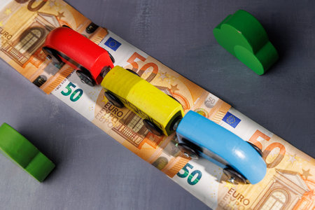 Small train on cash. Perfect for illustrating the high cost of public transport, financial exclusion and the struggle for affordable travel now.の写真素材