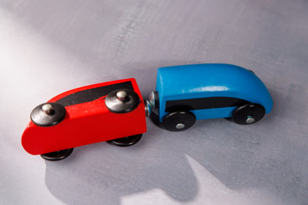 Wooden toy train accident on tracks. Use this to illustrate failed startup ideas, supply chain disruptions and general lack of progress in projects.の写真素材