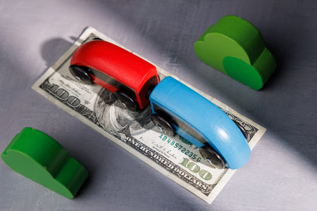 Wooden toy train on money bills. Ideal for representing high return investments, project growth and the rapid movement of global financial capital.の写真素材