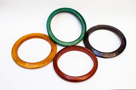 four wooden color bracelets isolated on whiteの写真素材