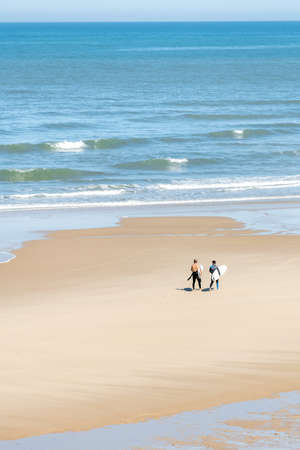 Surfers on the beach of Carcans, near Lacanau in Franceの写真素材