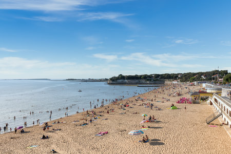 Fouras, France - 08-23-2019: end of a summer afternoon on the central beach of Fouras, a small seaside resort between Rochefort and La Rochelle popular with families. A promenade runs along the beachのeditorial素材