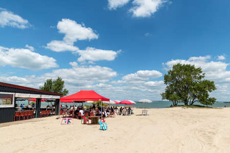 LE VERDON-SUR-MER, FRANCE - 06-06-2021: a restaurant is installed on the small beach of La Chambrette, with a terrace that allows you to eat with your feet in the sandのeditorial素材