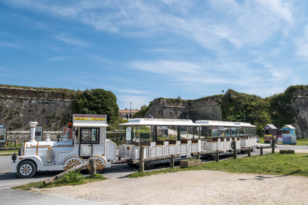 Chateau-d'OlÃ©ron, France - April 19, 2023. A small tourist train departs from the Citadelle d'OlÃ©ron parking lot for a 35-minute, 5-kilometer guided tour, as indicated on the trainのeditorial素材