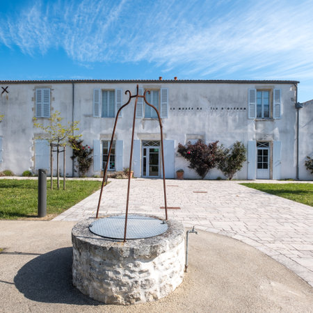 Saint-Pierre d'Oleron, France - April 19 2023: Old well at the entrance to the small municipal museum on the Ile d'Oleronのeditorial素材