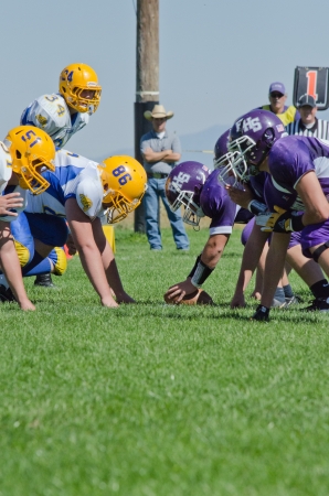 High school varsity football players lined up ready for play to beginのeditorial素材