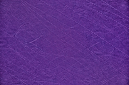 Dark purple background from balloon canvas with prominent creases for texture の写真素材