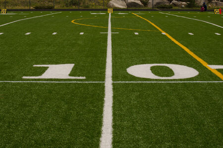 American Football 10 yard line marker in white on green artifical turfの写真素材