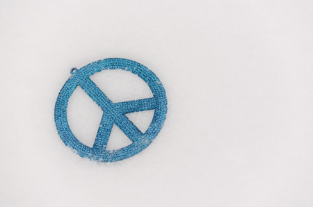 blue peace sign ornament isolated in snow2の写真素材