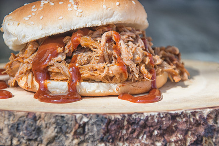 BBQ pulled pork sandwich on wood cutting boardの写真素材