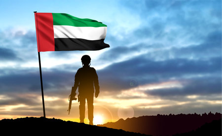 Silhouette of a soldier on background of the sunrise and UAE flag. Armed Forces of United Arab Emirates. Concept for Commemoration Day, Martyrs Day. eps10 vectorのイラスト素材