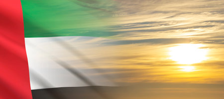UAE flag on background of cloudy sunset or sunrise. Background for National Dayの写真素材